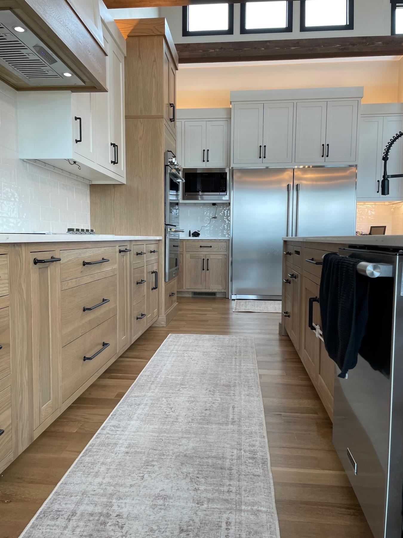Two-tone kitchen with modern lighting